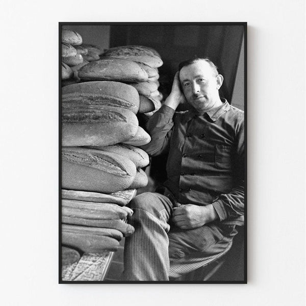 Normandy Landing Poster - A civilian sitting in front of a table covered with bread