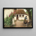 a woman near a farm with red hollyhocks - Hans Andersen Brendekilde — framed artwork on a wall