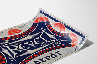 Parapluies Revel — Registered trademark, Lyon, Paris, shown on a curved sheet, viewed in perspective.