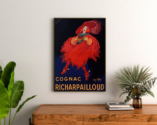 Vintage Cognac Richarpailloud advertisement poster, framed above a wooden dresser between plants.