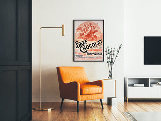Vintage poster Beef Chocolat, chocolaterie de la Drôme, framed in a living room with an orange armchair and a floor lamp.