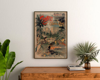 Vintage Cannes poster, Grand Hôtel des Pins, framed above a wooden dresser between plants.