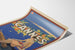Vintage Cannes poster, Les Sports Élégants, shown on a curved sheet, viewed in perspective.