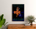 Vintage La Revue illustrée poster, framed above a wooden dresser between plants.