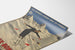 Vintage Les Eaux-Bonnes winter sports poster, shown on a curled sheet, perspective view.