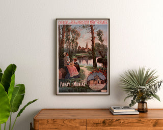 Vintage poster Paray‑le‑Monial, train, framed above a wooden dresser, flanked by plants.