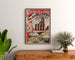 Vintage poster Paris, Saint-Denis, trains and trams, framed above a wooden dresser, between plants.