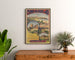 Vintage Pyrénées et Gascogne winter poster, framed above a wooden dresser between plants.