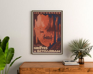 Vintage Pyrénées — Grottes de Bétharram poster, framed above a wooden dresser between plants.
