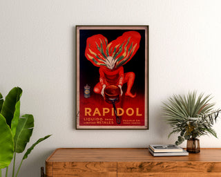 Vintage Rapidol poster, framed above a wooden dresser between plants.
