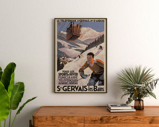 Vintage Saint-Gervais, Mont-d’Arbois poster, framed above a wooden dresser, between plants.