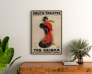 Vintage poster The Geisha, Daly’s Theatre, framed above a wooden dresser, flanked by plants.