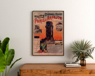Vintage tram poster Paris–Arpajon, framed above a wooden dresser, between plants.