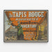 Vintage poster for Au Tapis Rouge store opening, April 2 — framed artwork on a wall