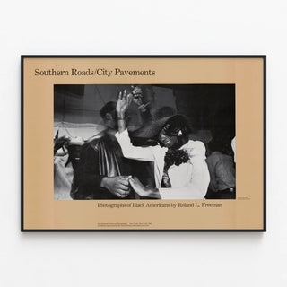 Vintage poster Southern Roads / City Pavements by Roland Freeman — framed artwork on a wall