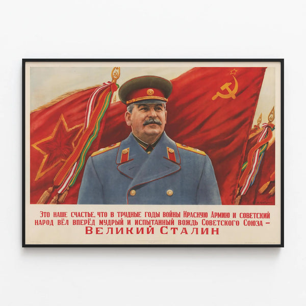 Soviet propaganda poster 'The Great Stalin' with military portrait — framed artwork on a wall