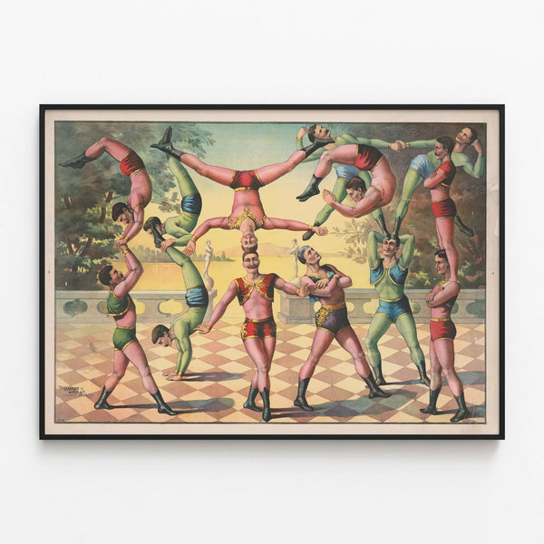 Vintage poster of male acrobats balancing — framed artwork on a wall